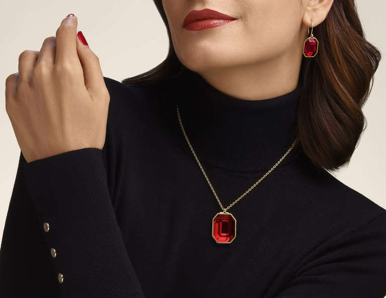Woman wearing pendant , and earrings from Harcourt collection