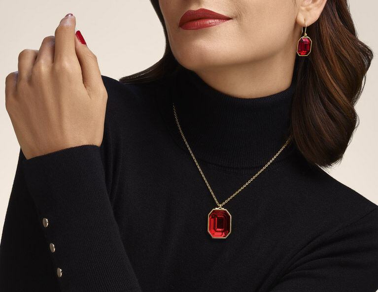 Woman wearing pendant , and earrings from Harcourt collection