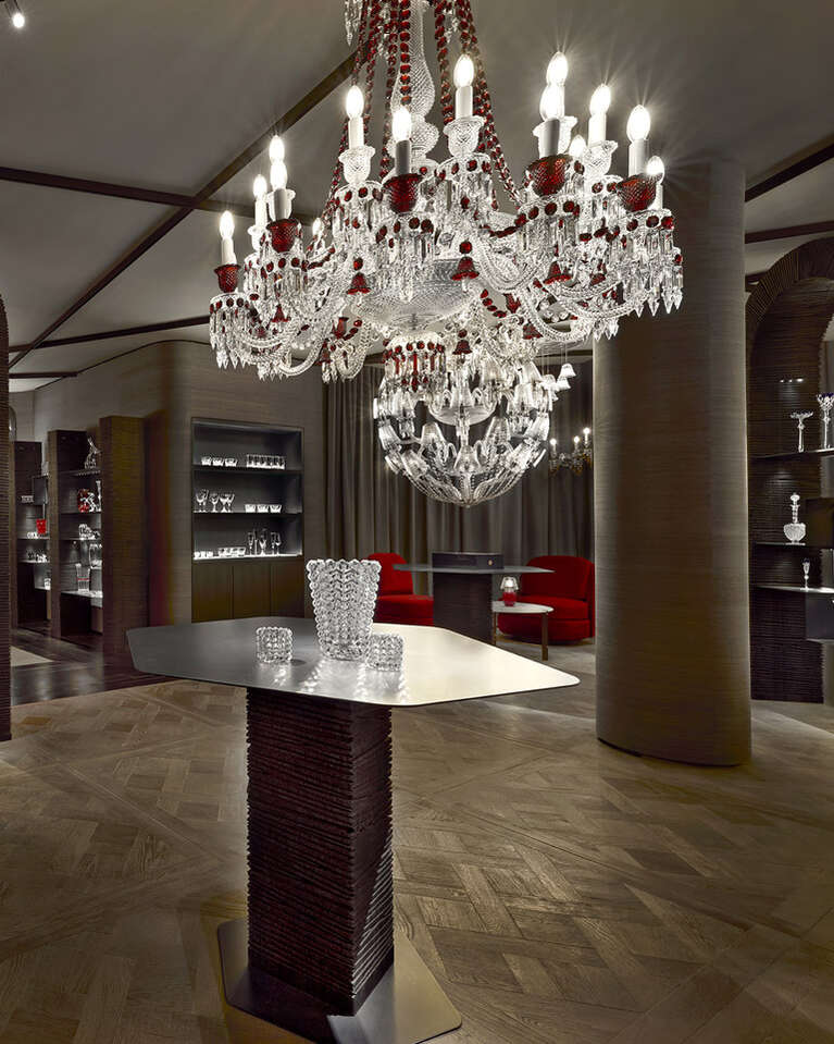 Zenith ceiling suspended above a table with baccarat products