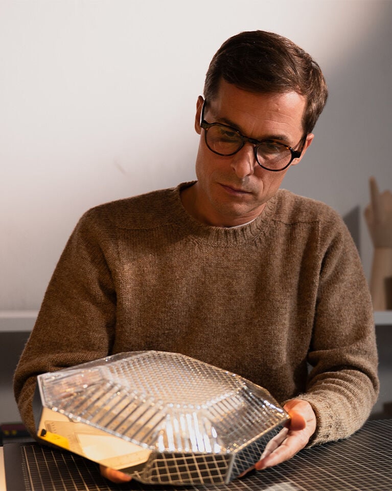 Ambroise Maggiar looking at his Octogone lamp