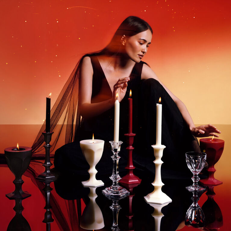 Girl sitting in the middle of wax candles